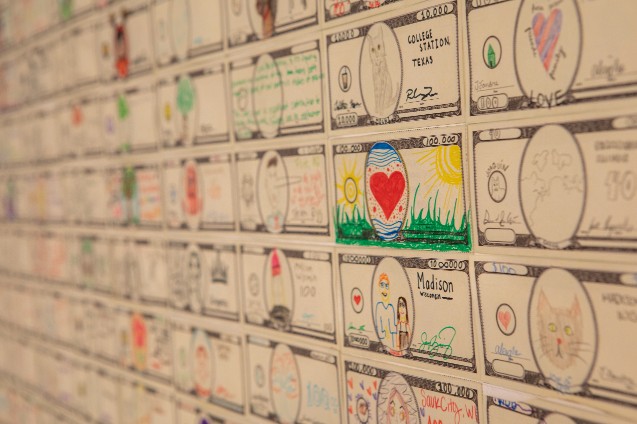 A close-up of a wall lined with Fundred Dollar Bills