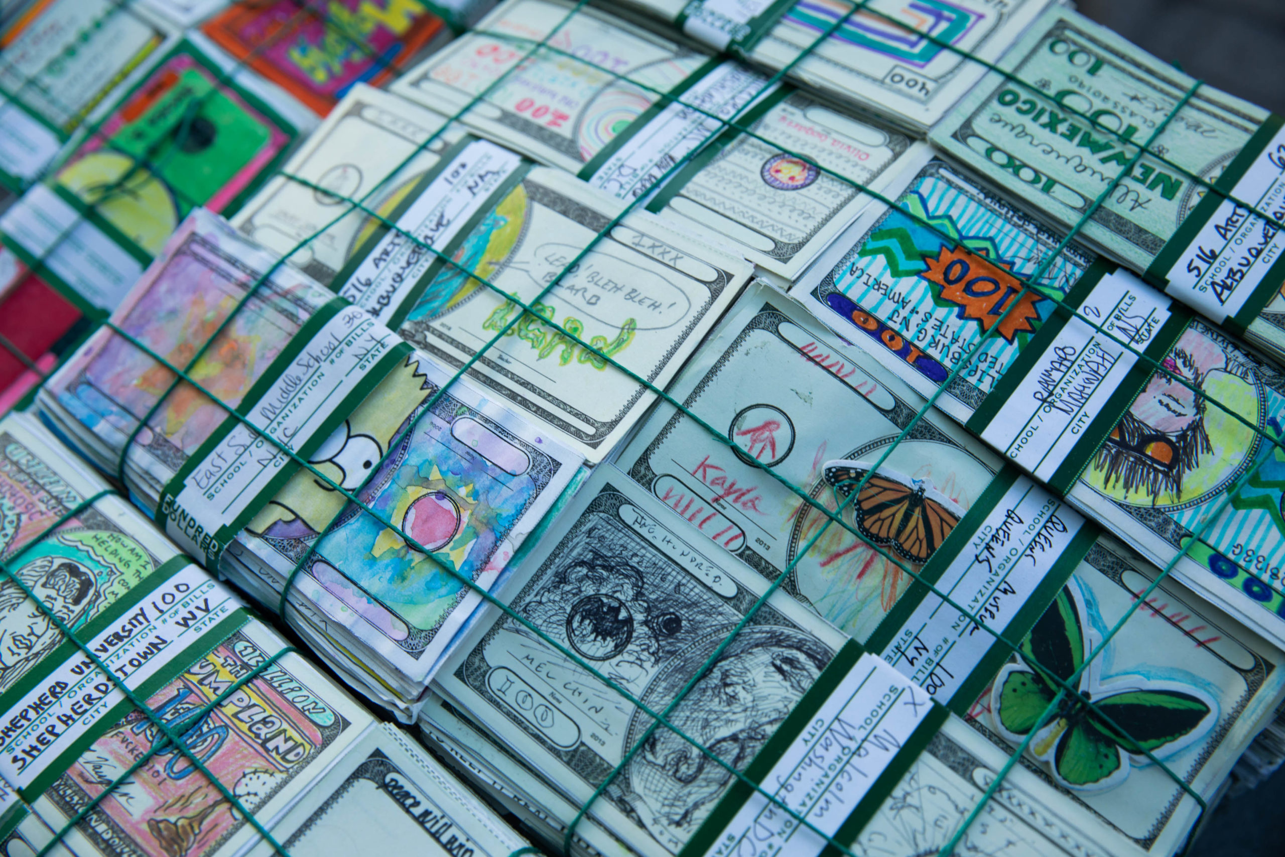 A close-up of colorful Fundred Dollar Bills tied into stacks.